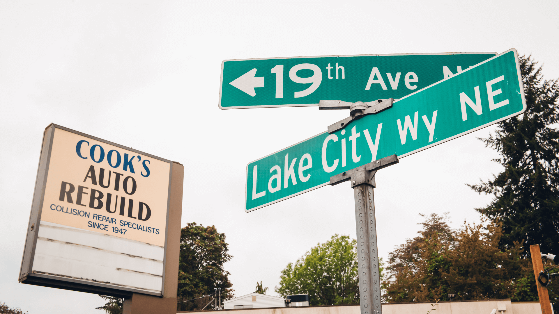 Cook's Auto sign next to street signs.