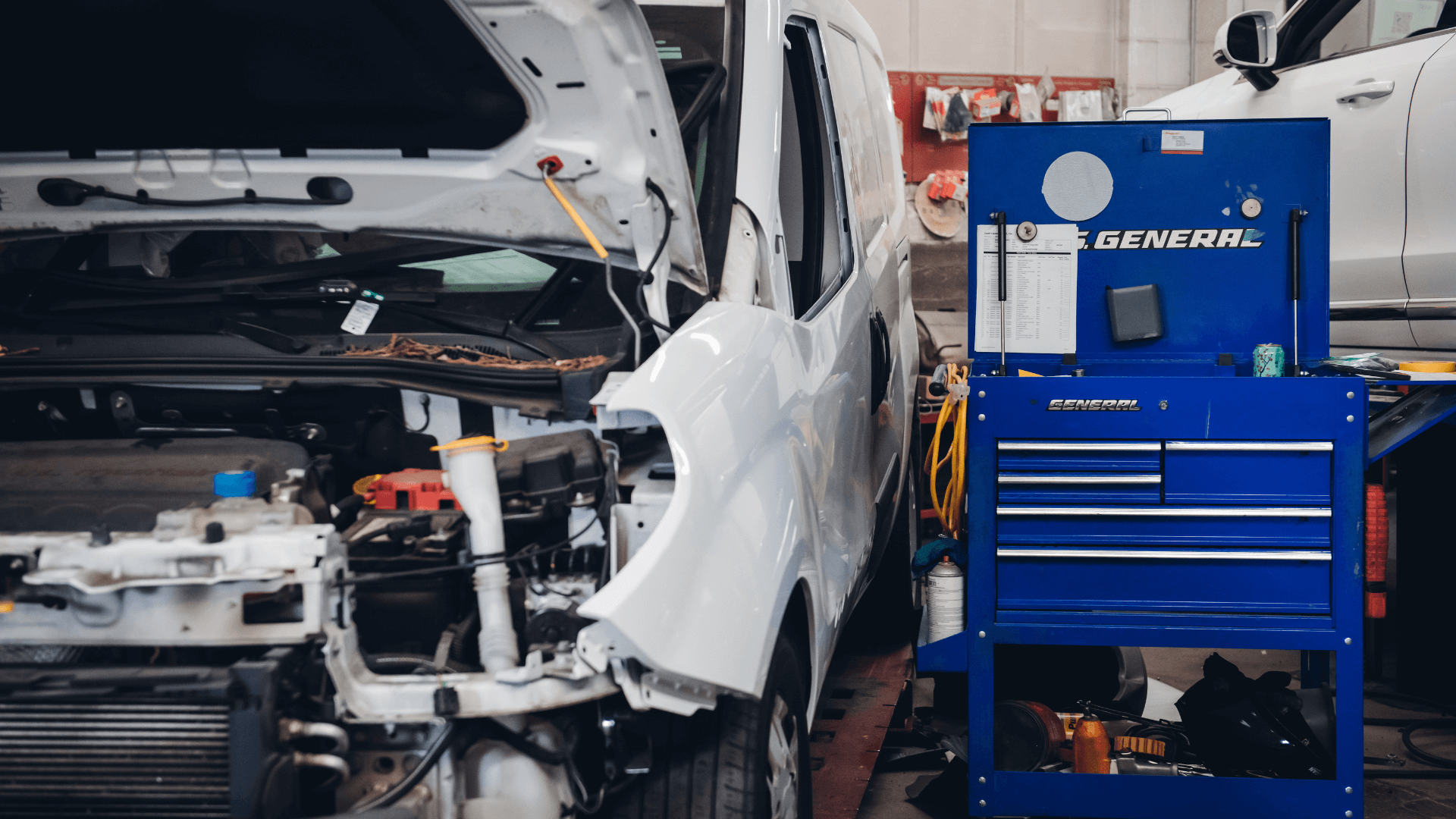 A work station next to a broken car.